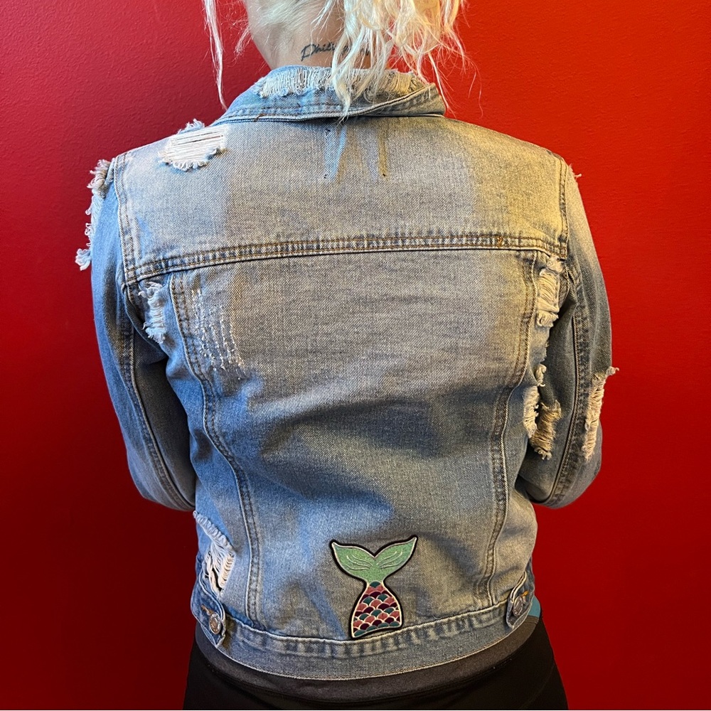 Distressed Jean jacket. Size small with a custom mermaid fin patch.